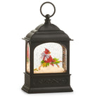 Black lantern-shaped snow globe with a cardinal Christmas scene inside on a white background